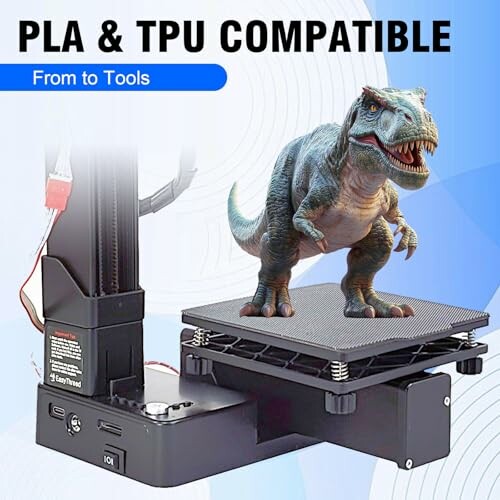 3D printer with a dinosaur model on the print bed, showcasing PLA and TPU compatibility.