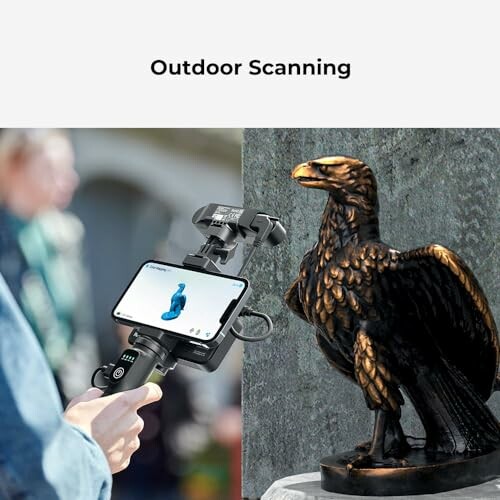 Person using a smartphone and scanner to 3D scan an eagle statue outdoors.